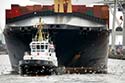 Tug with containership in Hamburg