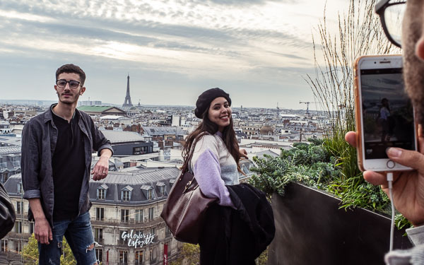 Couple on Galeries Lafayette rooftop terrace in Paris.