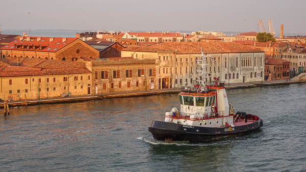 Tugboat deadheading in Venice's Giudecca Canal.