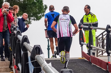 Venice Marathon runners on a bridge by the Giudecca Canal